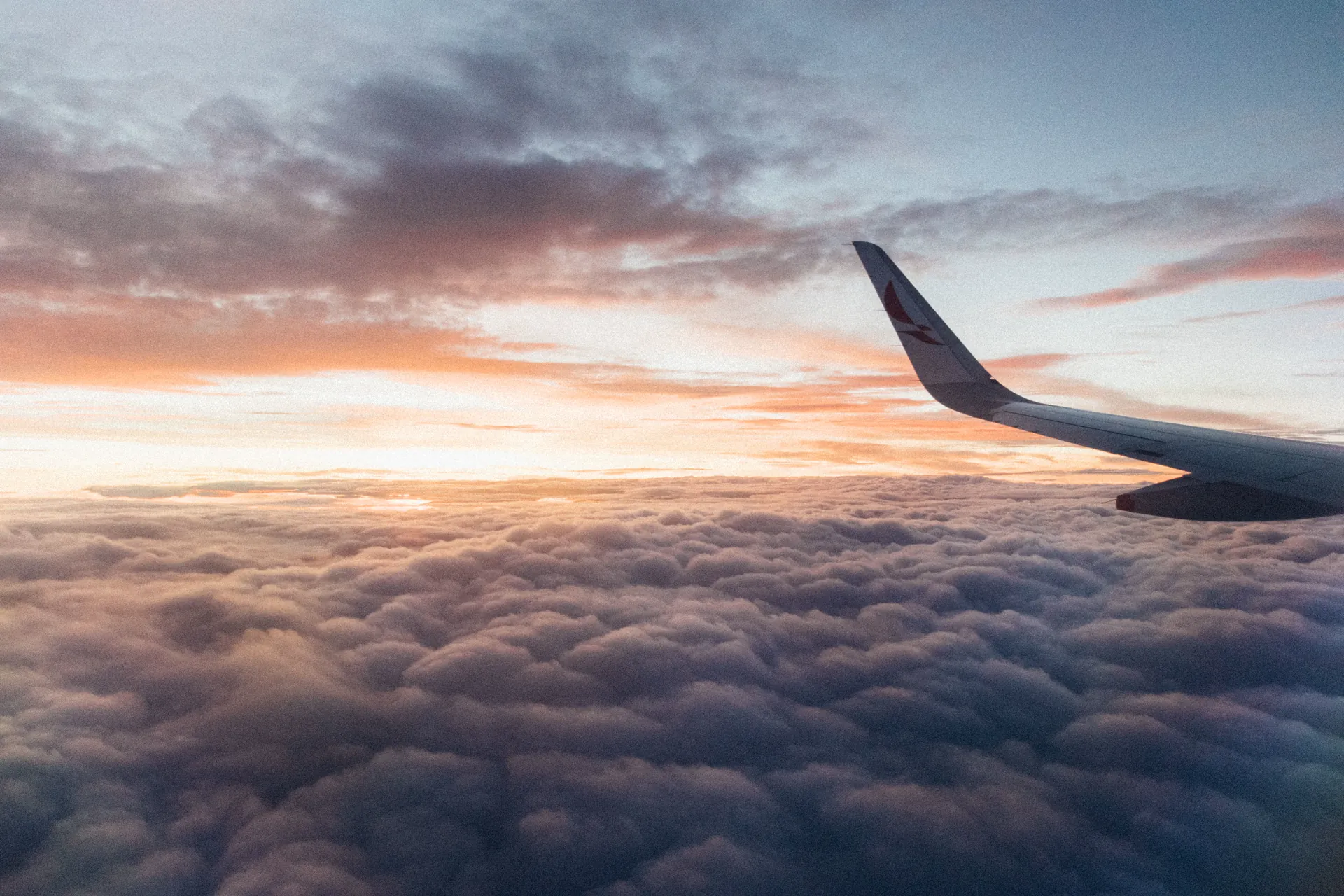 Aircraft wing above a sea of clouds